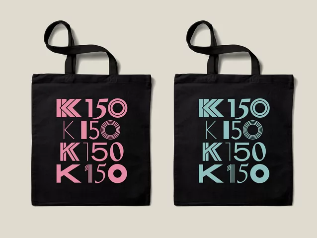 Graphic showing both sides of the Kohler 150th anniversary commemorative canvas bag in black, featuring the K150 logo and tagline, Come All Creators, in vibrant pink color.