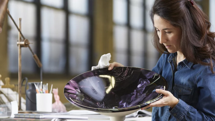 Image of Dana Morales, Industrial Designer at Kohler Co., working on a glass sink design at her office within the Kohler factory.